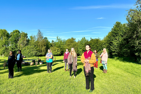 women-outside-grass-sunshine
